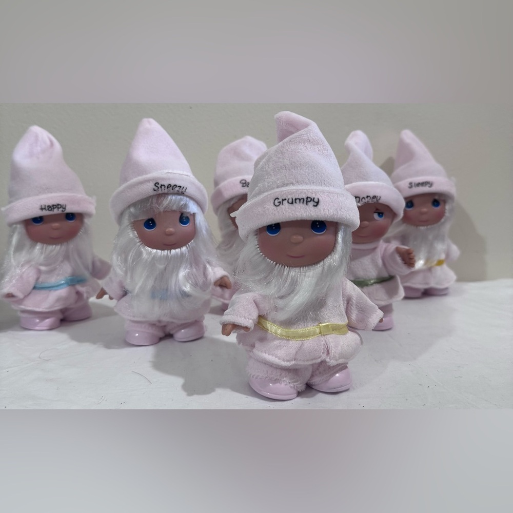 Figures of pink and white dwarfs of precious moments